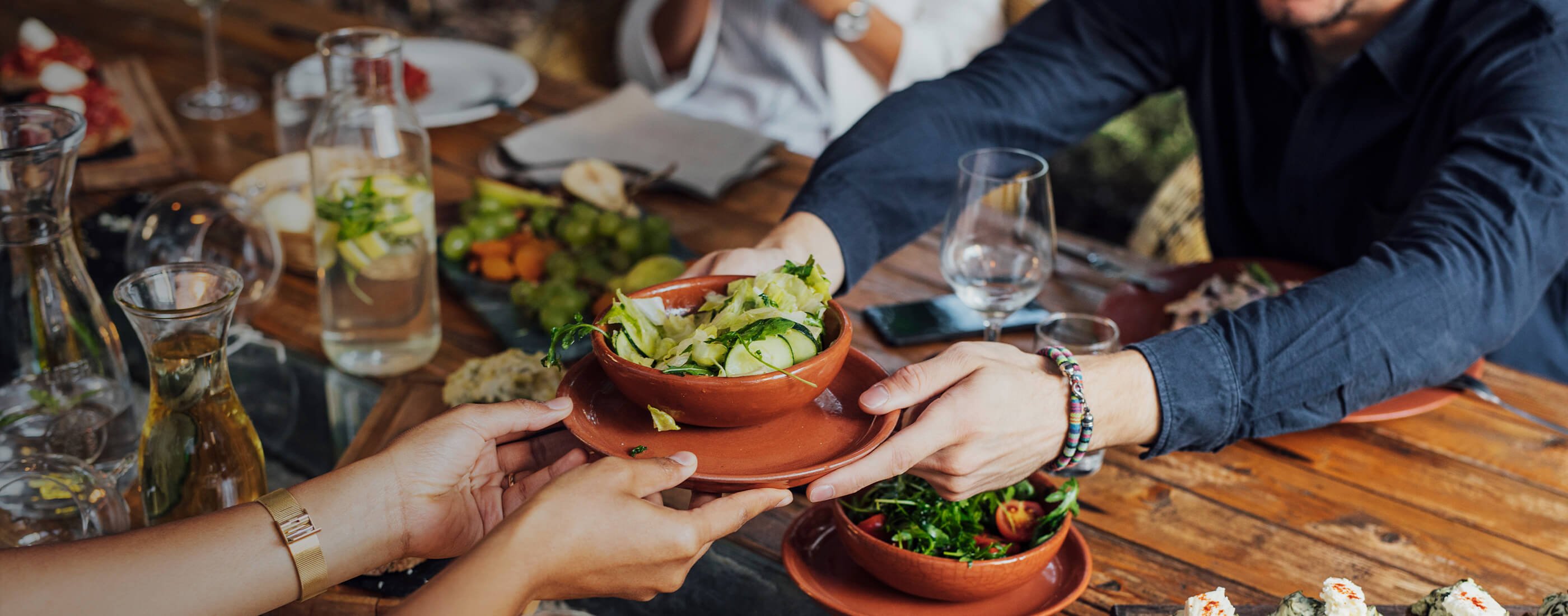 Fresh food being passed across a table